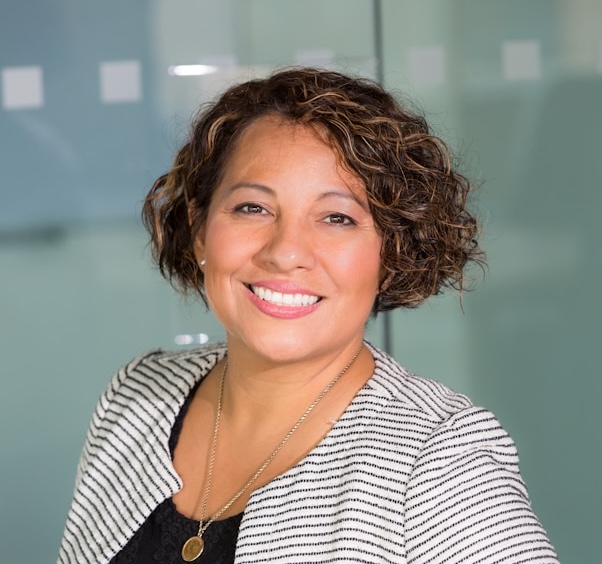 Headshot of a professional-looking woman in an office.